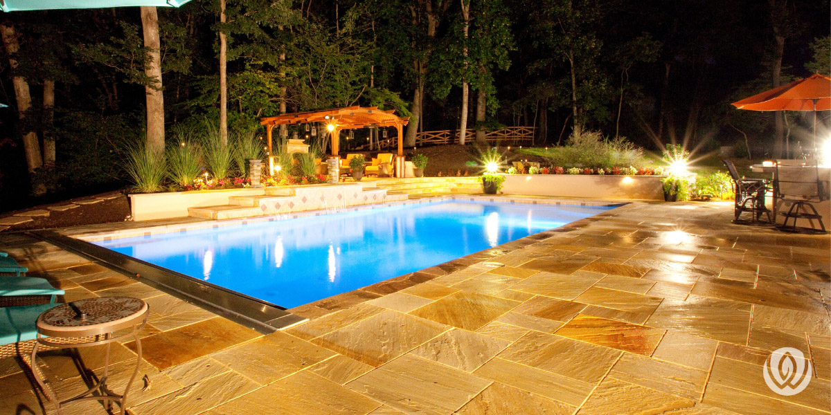 custom-concrete-pool-nighttime-oasis-backyard-pool