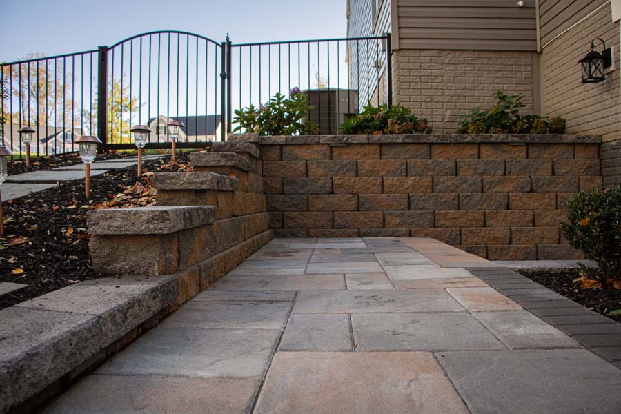 Stone Patio with retention wall and wrought iron fence