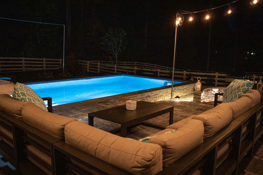 View from patio of pool at night