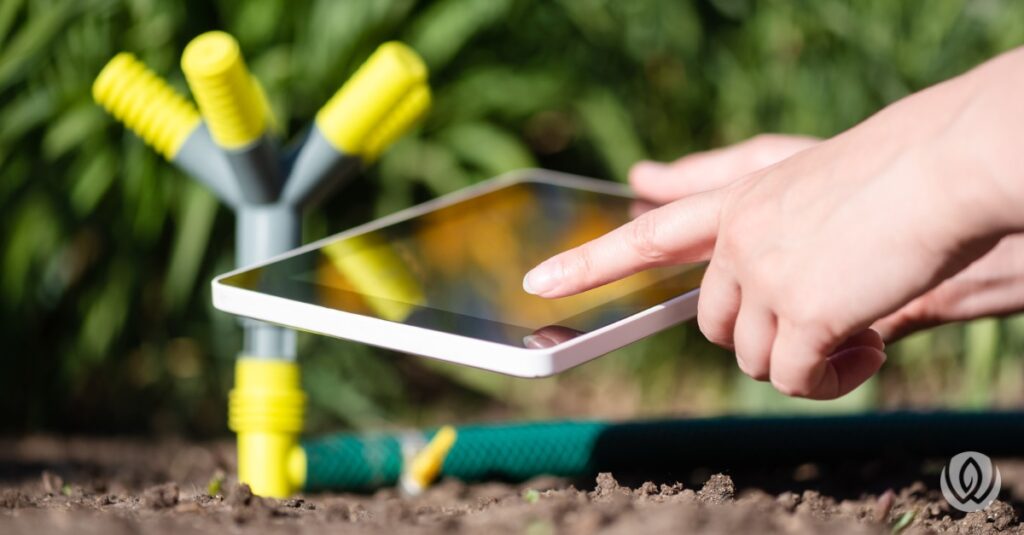 homeowner using smart garden in backyard