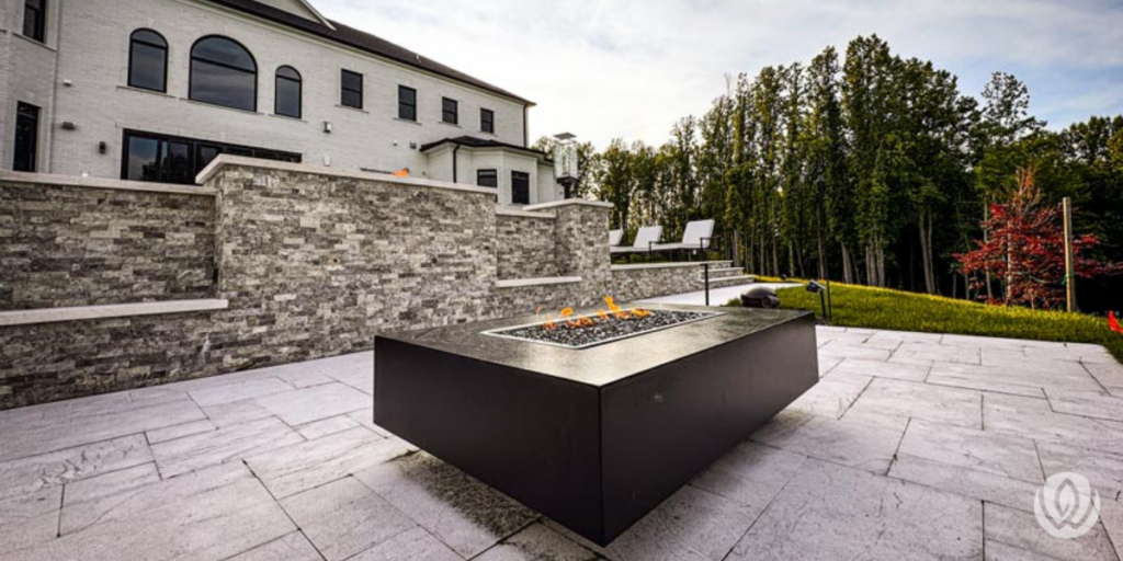Modern fire pit on stone patio with seating area