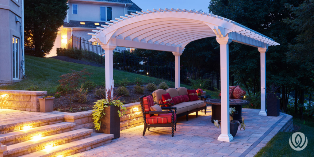 Backyard pergola patio with retaining wall structure supporting multi-level outdoor space